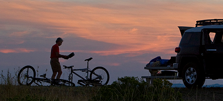 Mountain biker on a ridge at sunset